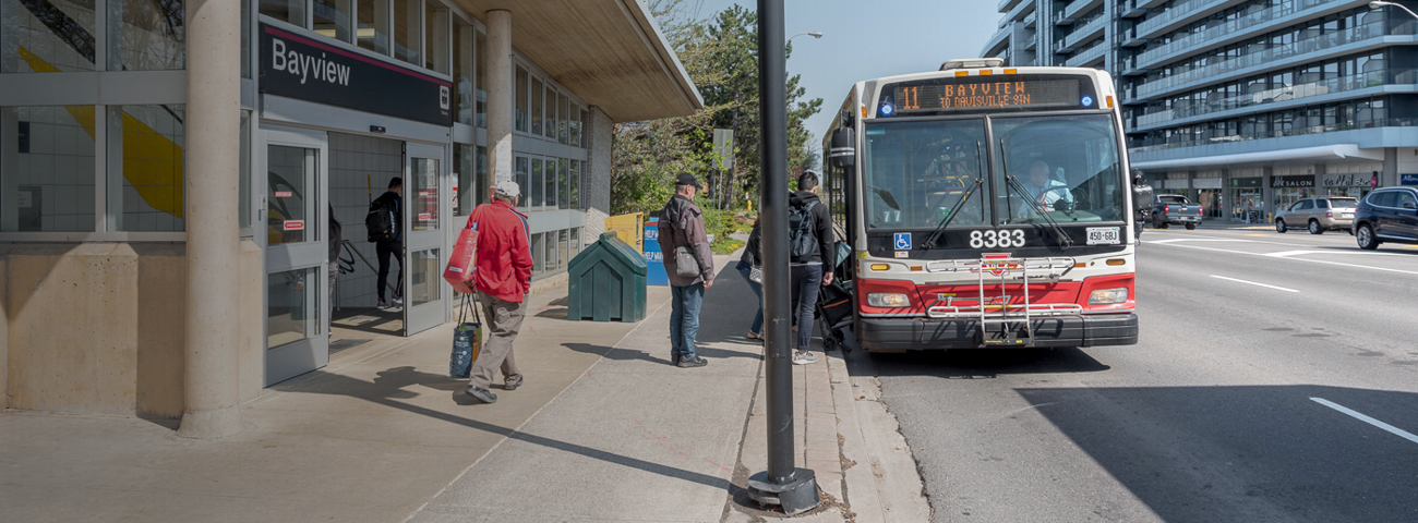 Passengers boarding TTC bus in front of Bayview Station