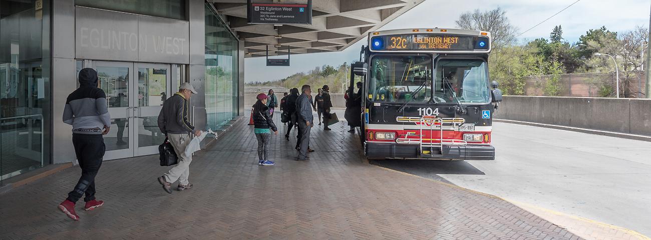 Passengers boarding bus at Eglinton West Station bus stop